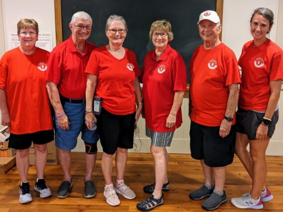 6 board members modeling the fronts of the polo and t-shirt